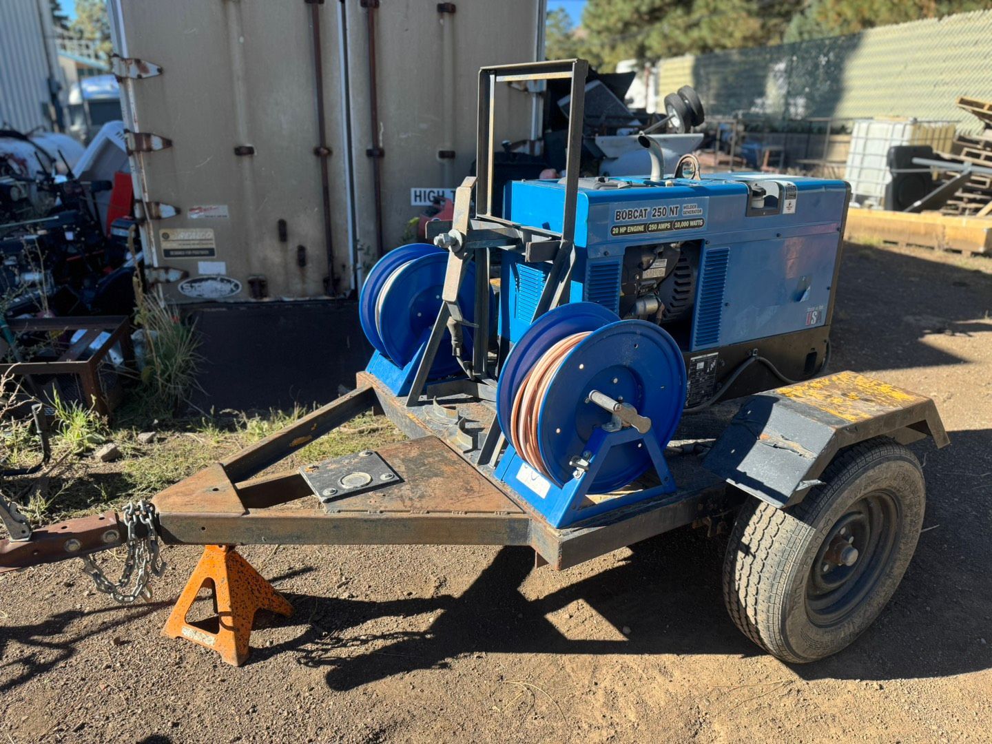Open red toolbox drawer filled with various tools, set against a workshop floor.