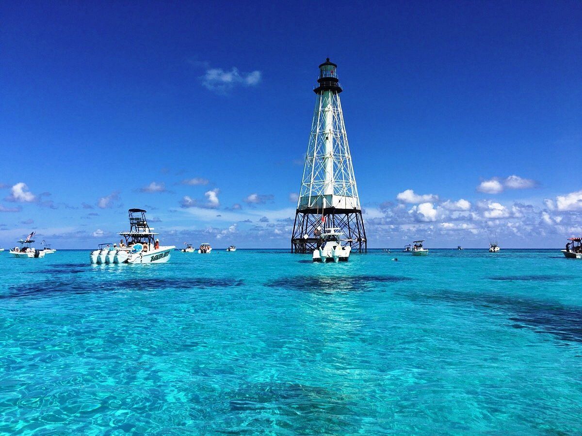 A group of boats are floating on top of a body of water.