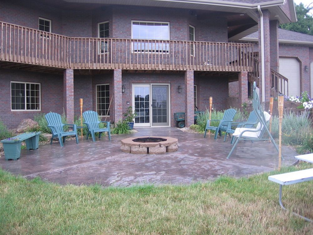 A large house with a fire pit in front of it