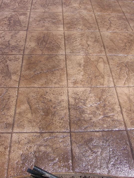 A close up of a tiled floor with a pen on it.