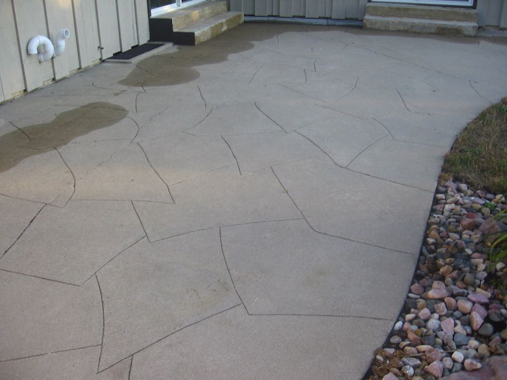 A concrete walkway leading to the front door of a house