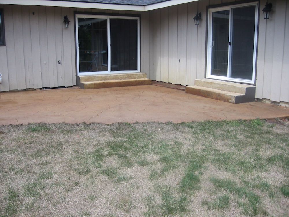 A house with a patio and sliding glass doors