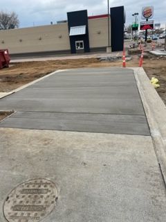 A concrete walkway is being built in front of a burger king restaurant