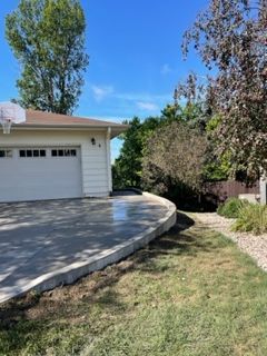 A white house with a basketball hoop in front of it.