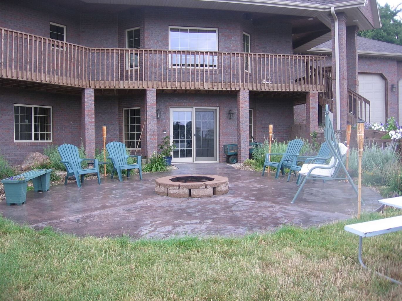 A large house with a fire pit in front of it