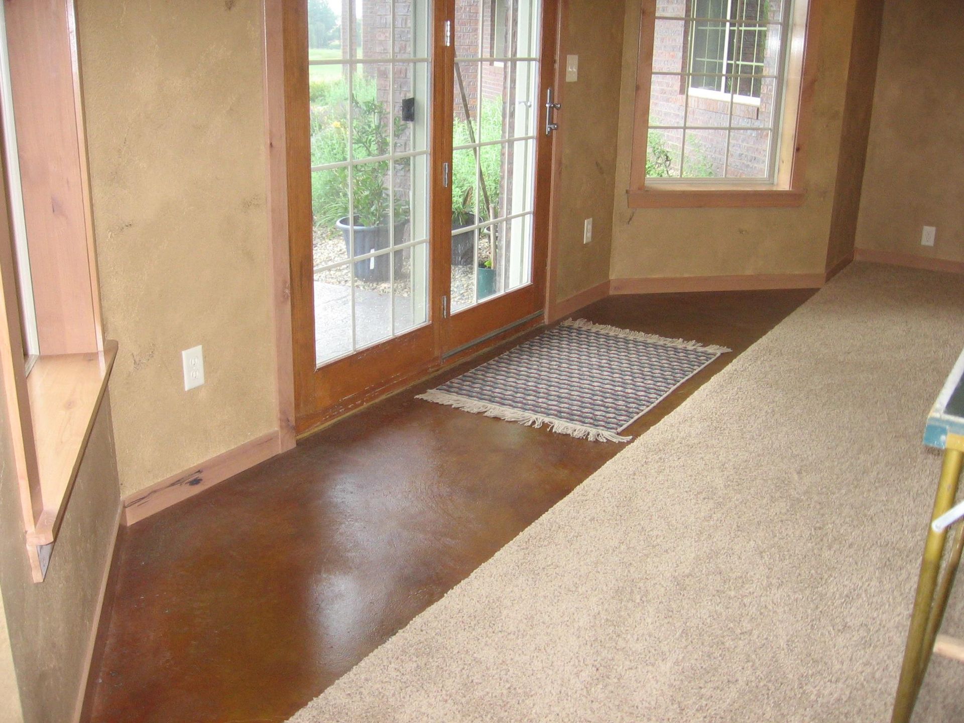 There is a rug on the floor in the middle of the room.