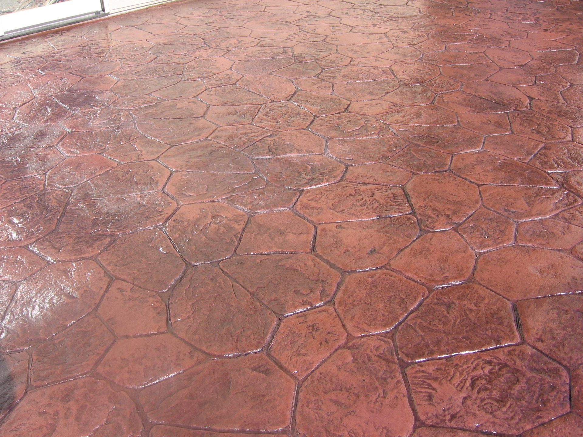 A red concrete floor with a hexagonal pattern