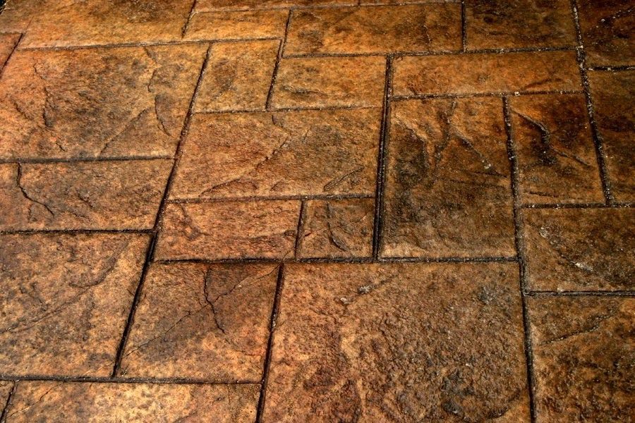A close up of a brick floor with a diagonal pattern