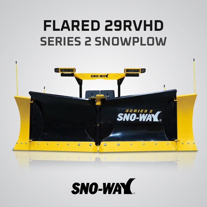 White pickup truck with a snowplow clearing a snow-covered road.