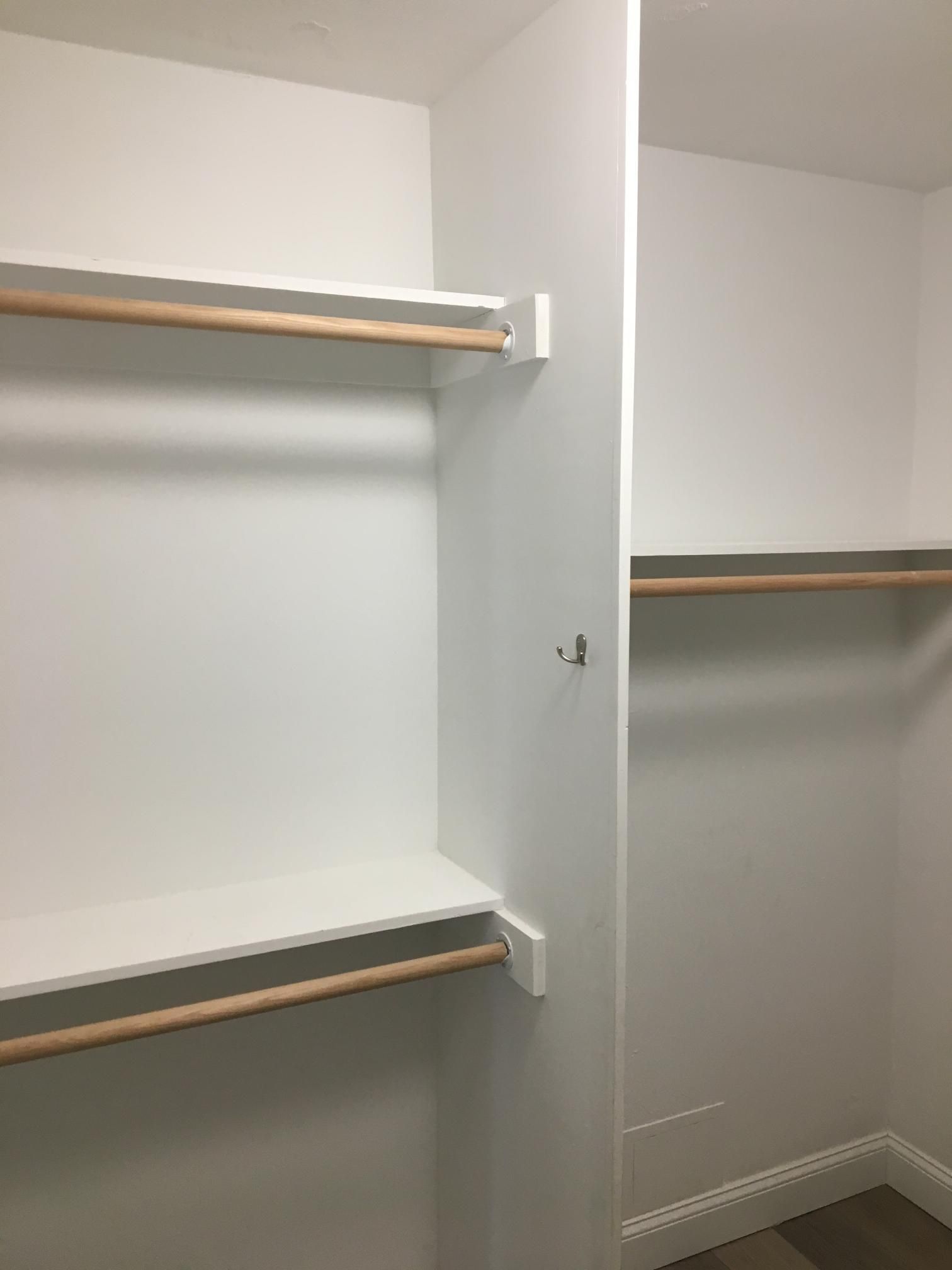 White closet interior with shelves and clothing rods.