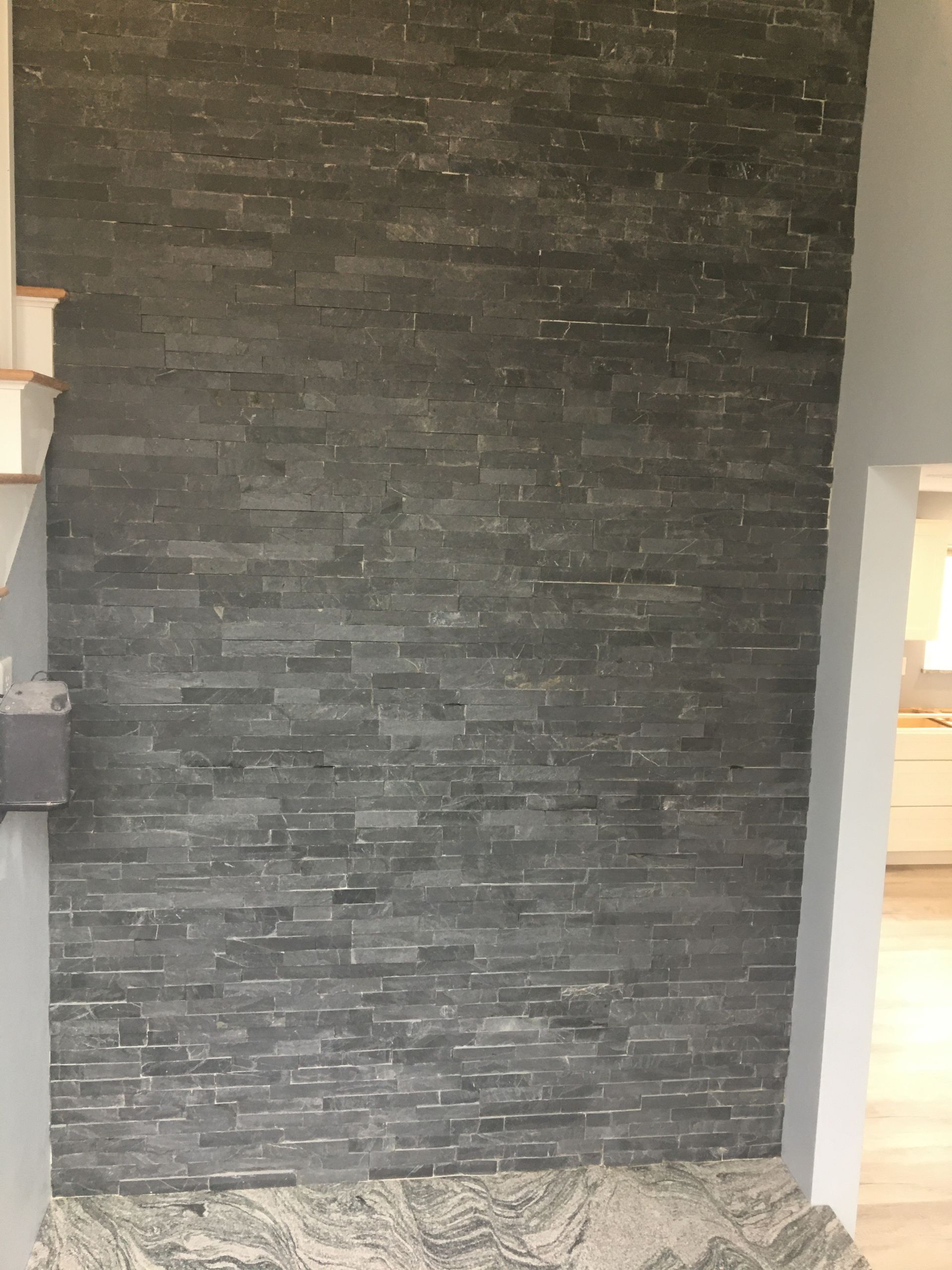 Grey stone veneer wall.
