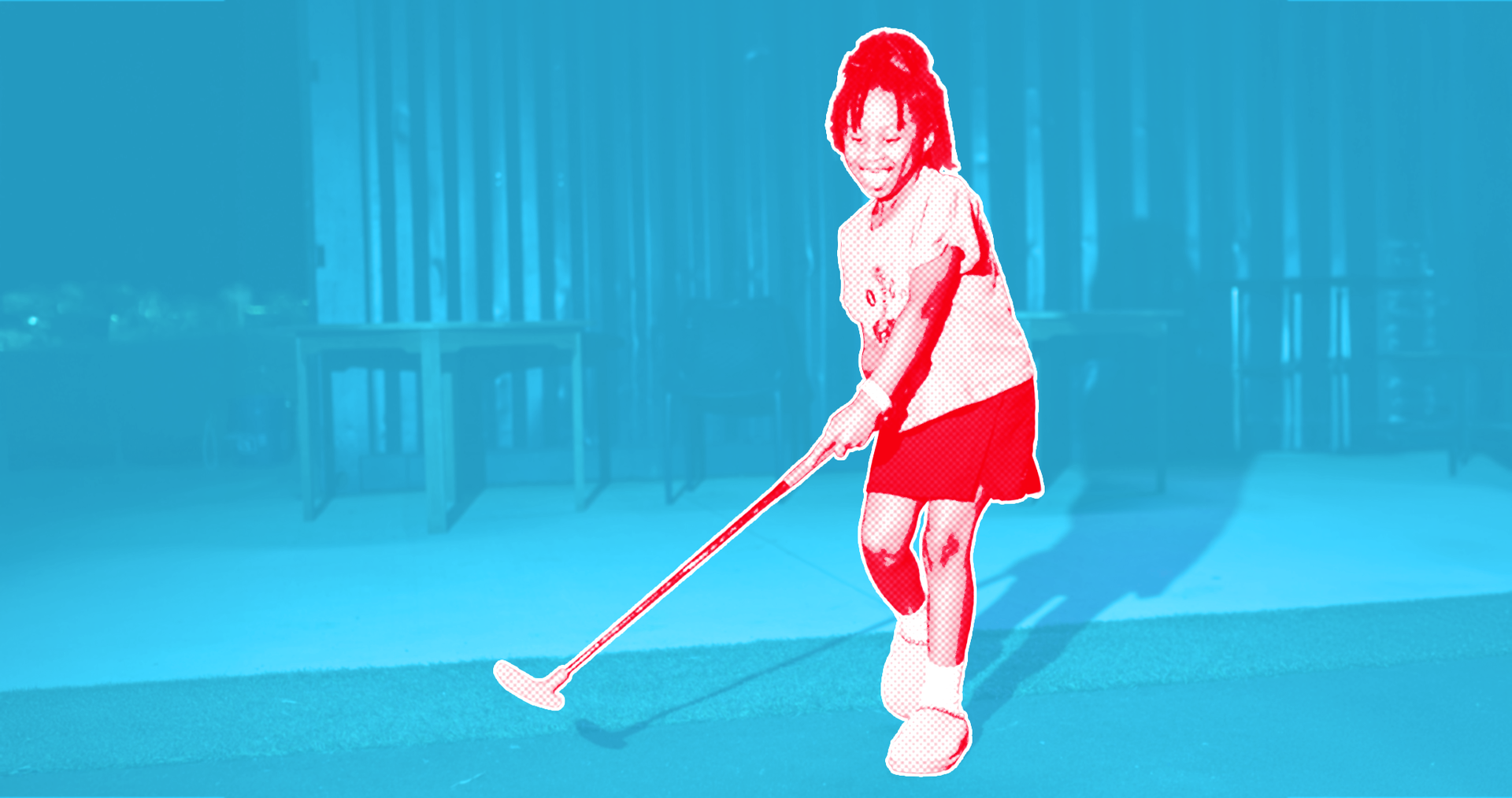 A man is playing a video game on a baseball field.