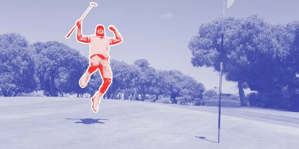 A man is jumping in the air while holding a golf club on a golf course.
