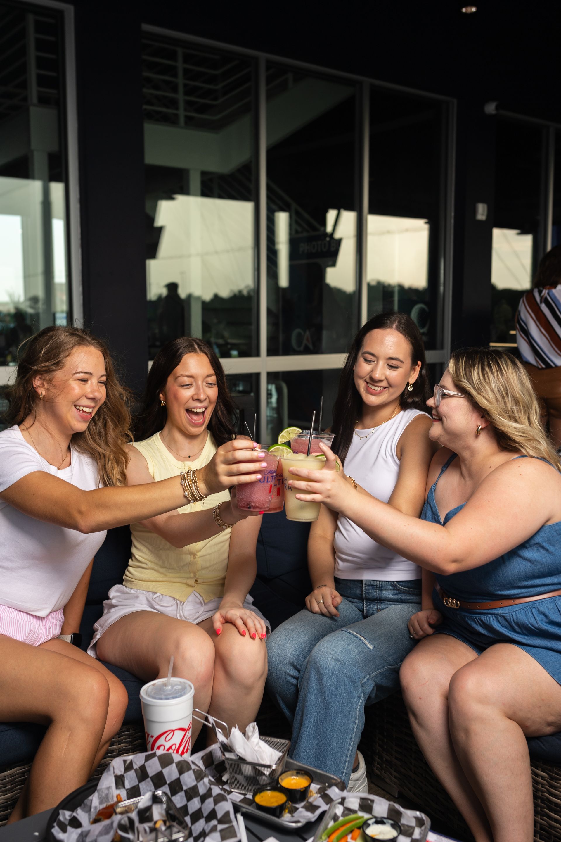 A shrimp sandwich is sitting on a metal tray on a table.