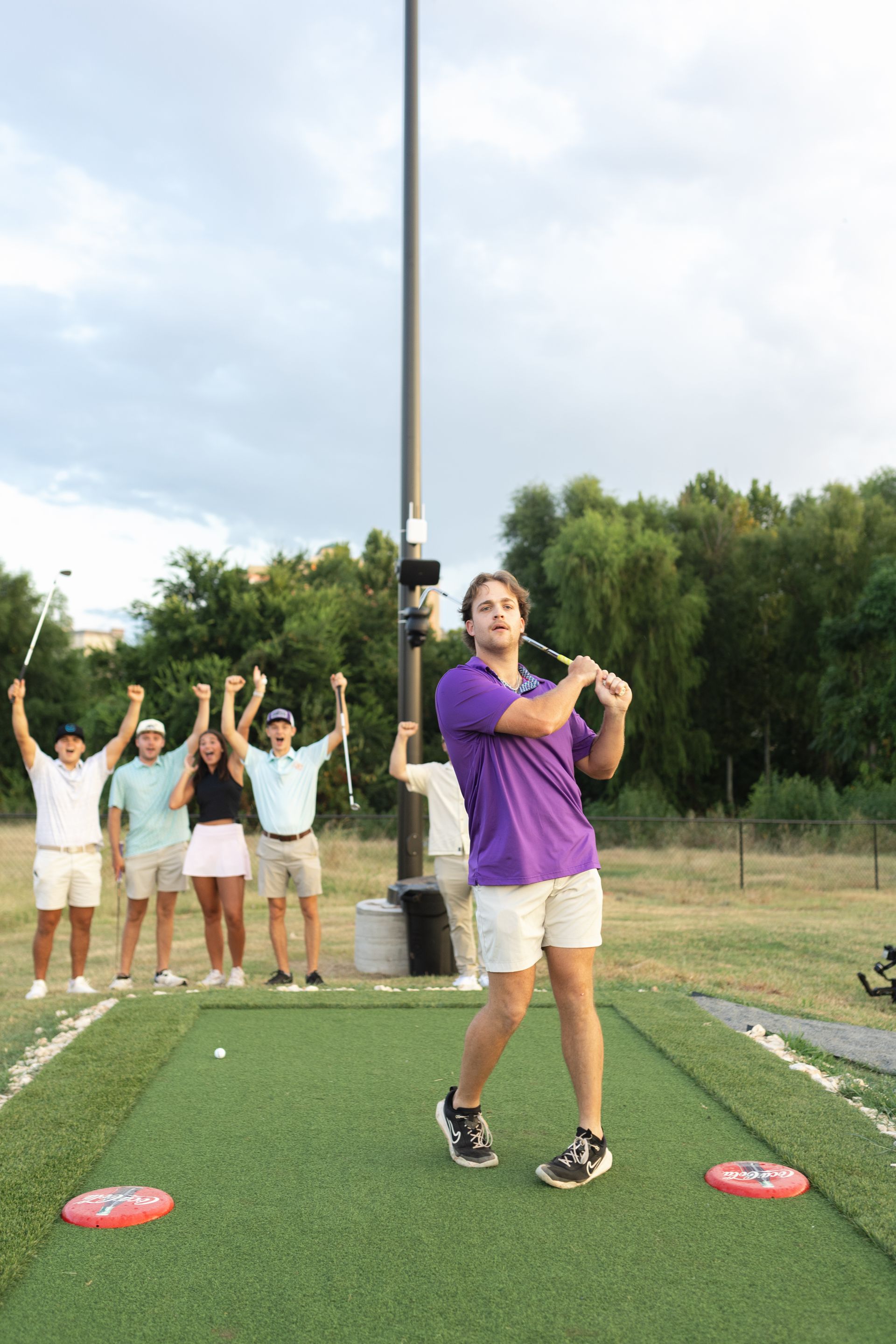 A group of women are posing for a picture on a golf course.
