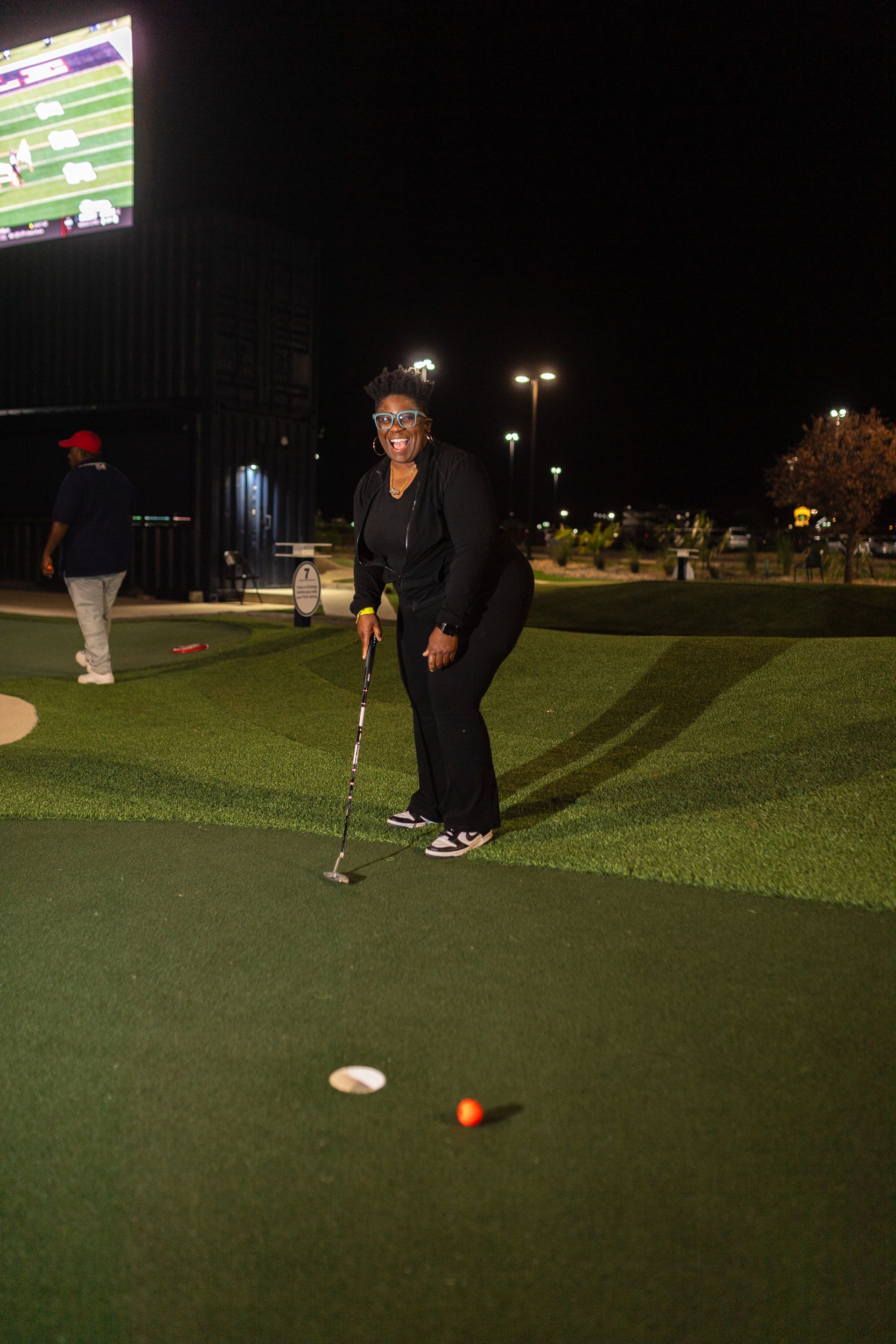 A group of women are posing for a picture on a golf course.
