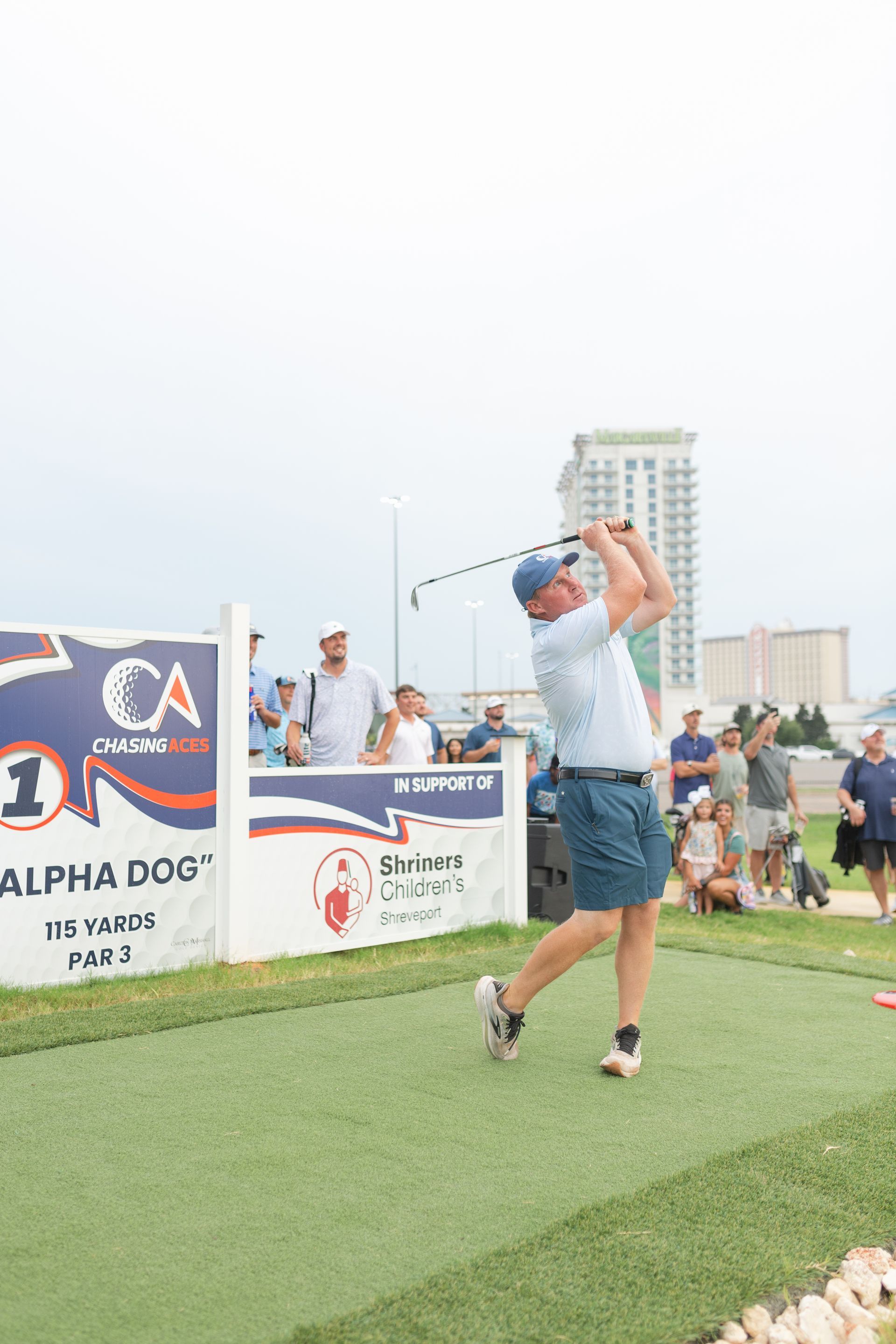 A group of people are playing a game of golf on a green.