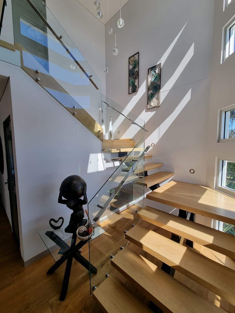 A Wooden Staircase With A Glass Railing In A House — South Coast Glass In South Nowra, NSW