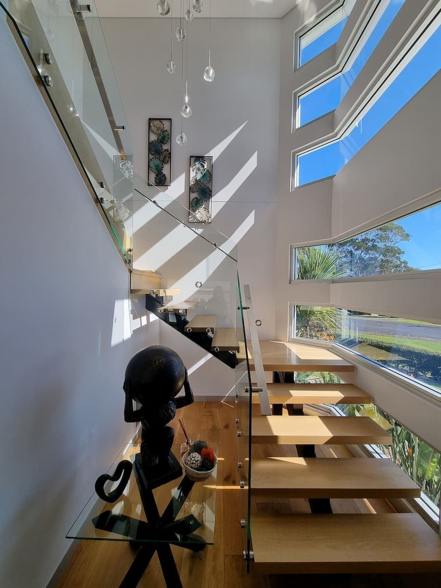 A Staircase With A Glass Railing And A Globe On A Table — South Coast Glass In South Nowra, NSW