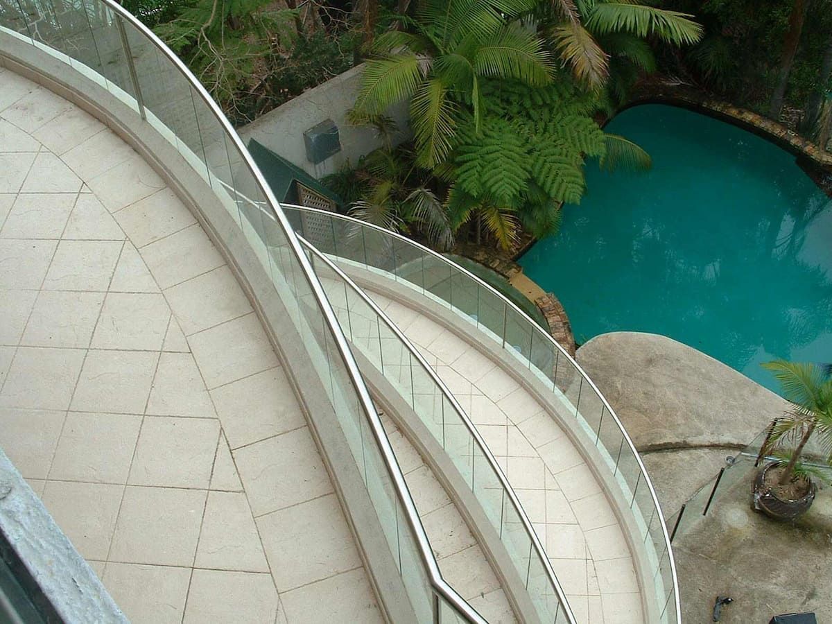 Stairs Leading Up To A Pool With A Glass Railing — South Coast Glass In South Nowra, NSW