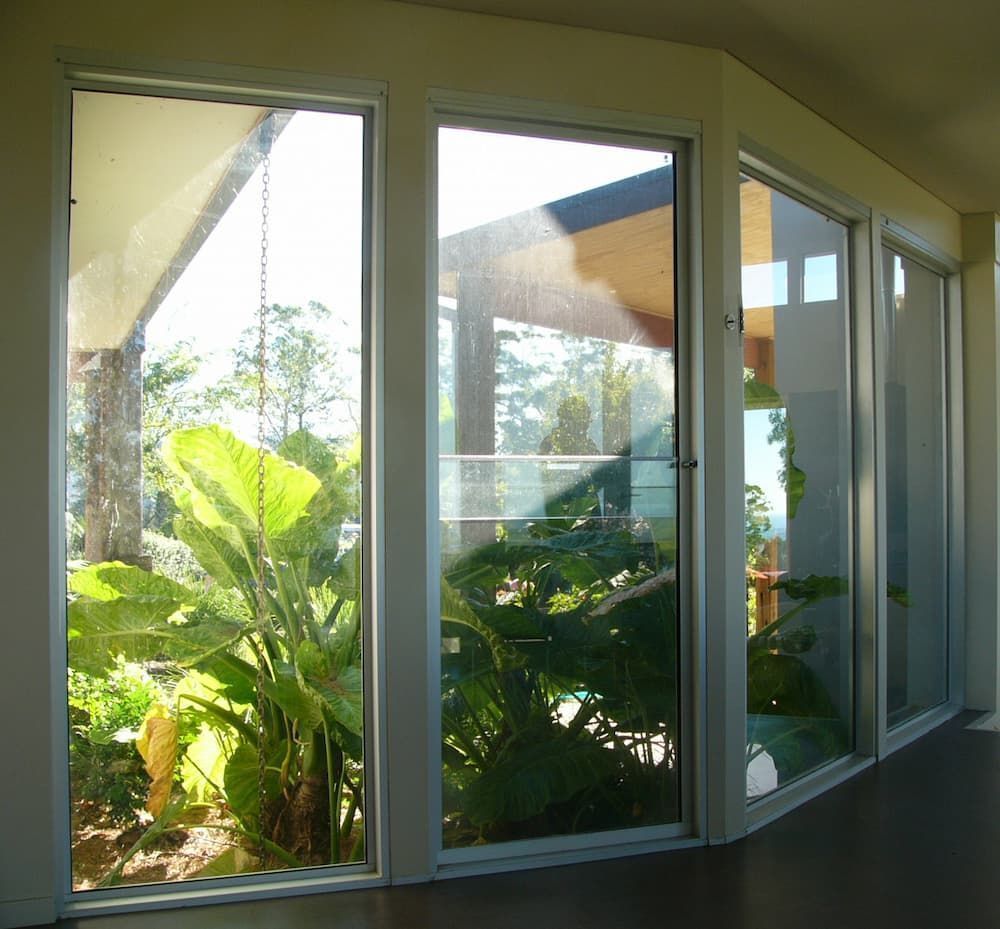 A Room With A Lot Of Windows And Plants Behind Them — South Coast Glass In South Nowra, NSW