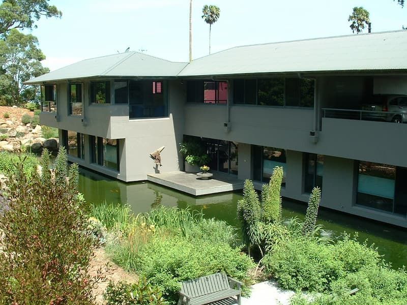 A Large Building With A Pond In Front Of It — South Coast Glass In South Nowra, NSW