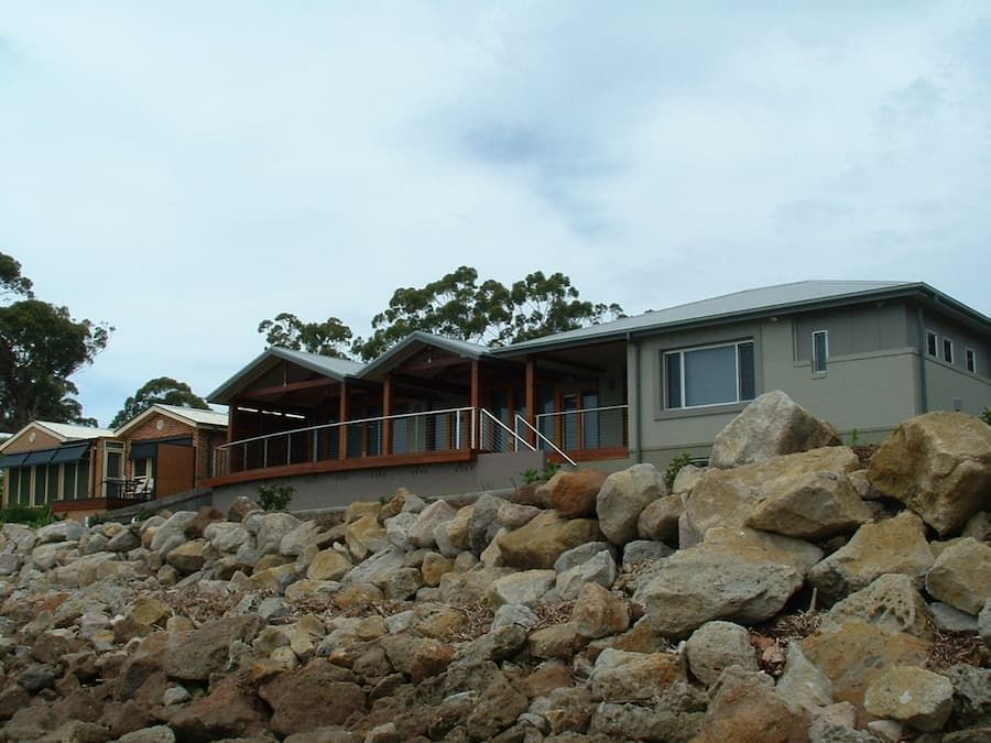 A House Sits On Top Of A Pile Of Rocks — South Coast Glass In South Nowra, NSW