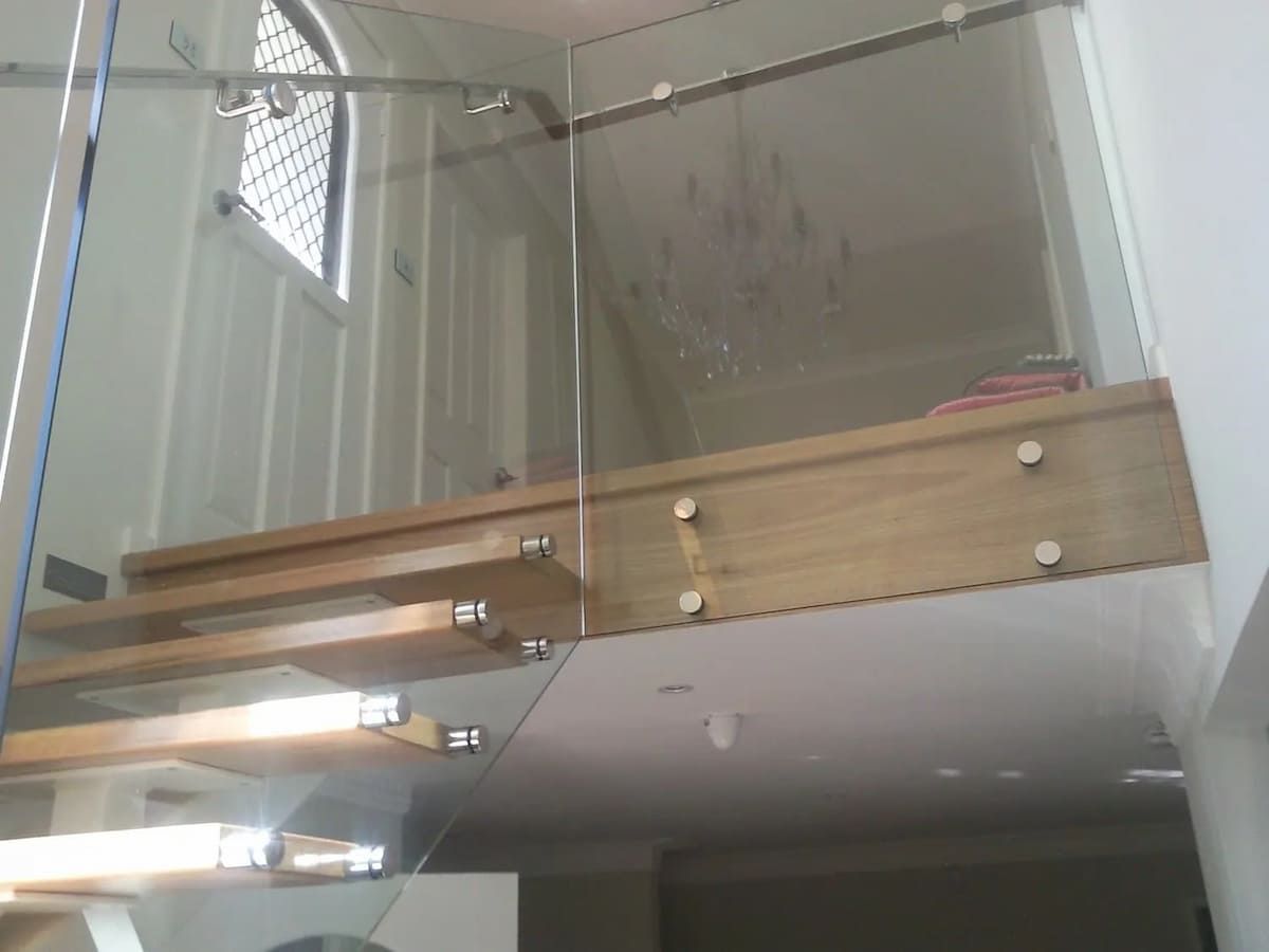 A Staircase With A Glass Railing And Wooden Steps — South Coast Glass In South Nowra, NSW