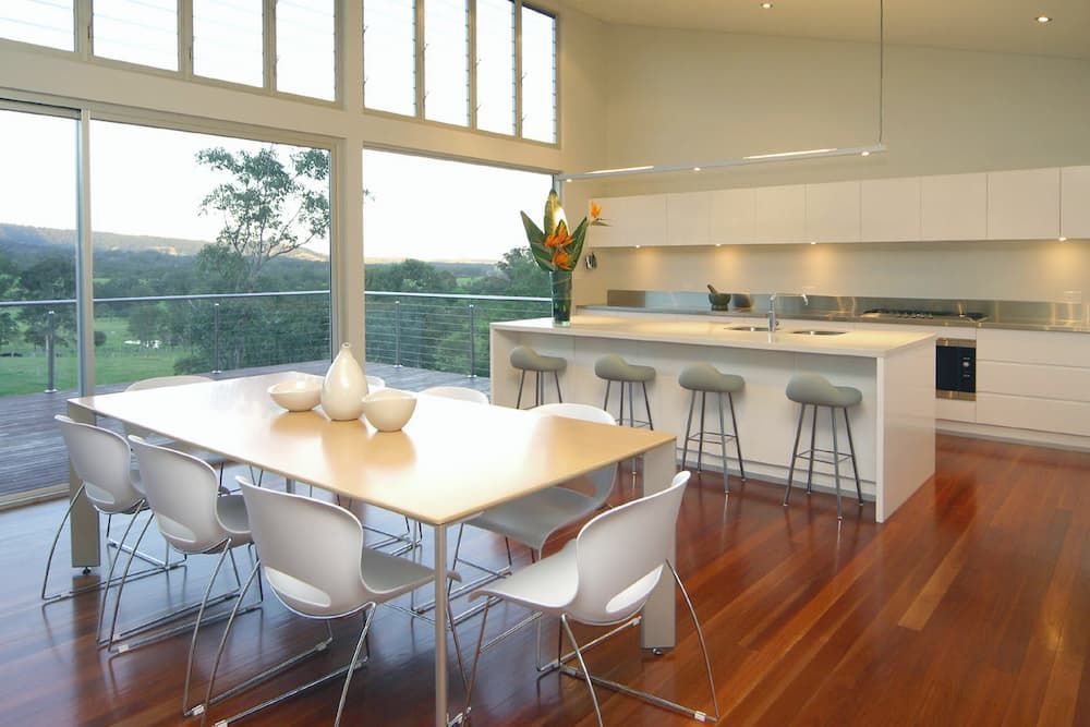 A Kitchen And Dining Area With A Large Table And Chairs — South Coast Glass In South Nowra, NSW
