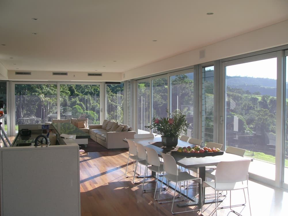 A Living Room With A Table And Chairs And A Lot Of Windows — South Coast Glass In South Nowra, NSW