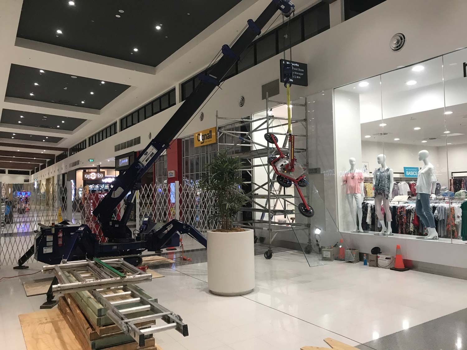 A Small Crane Inside the Mall Installing Glass Wall — South Coast Glass In South Nowra, NSW
