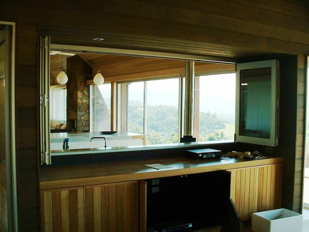 A Kitchen With A Lot Of Windows And Wooden Cabinets — South Coast Glass In South Nowra, NSW