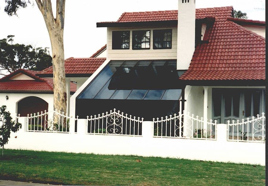 A White House With A Red Tile Roof And A White Fence — South Coast Glass In South Nowra, NSW