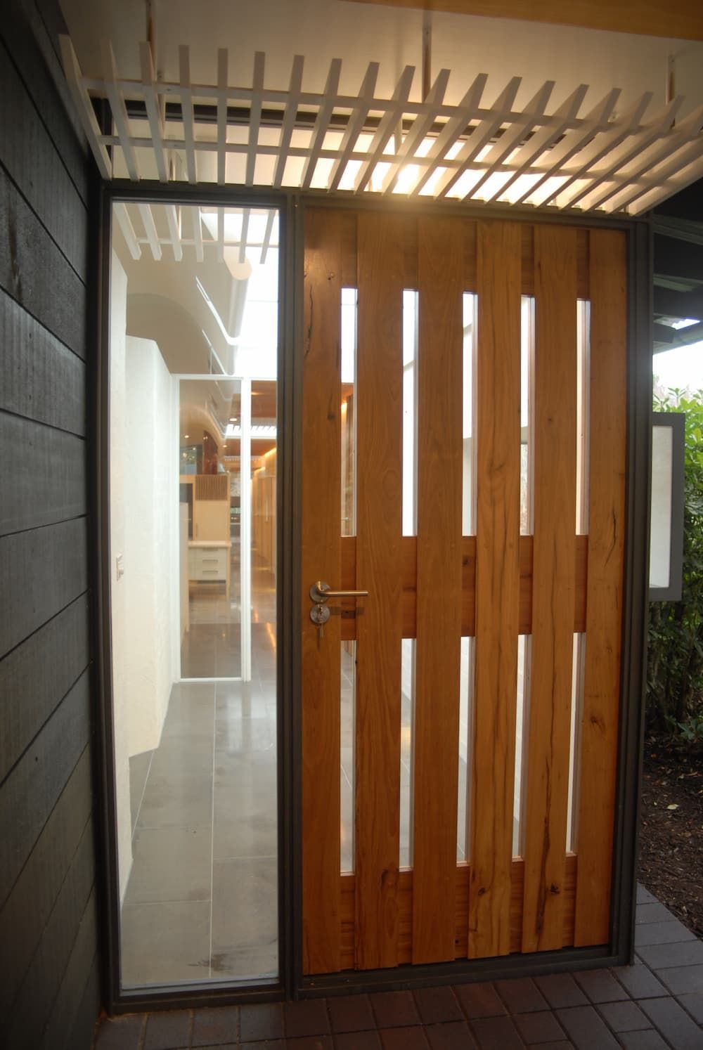 A Wooden Door With A Metal Frame And A Glass Door — South Coast Glass In South Nowra, NSW