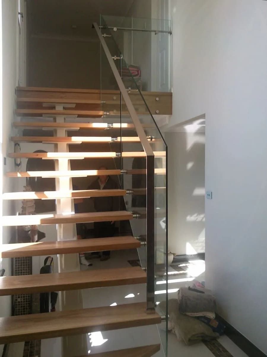 A Staircase With Wooden Steps And A Glass Railing — South Coast Glass In South Nowra, NSW
