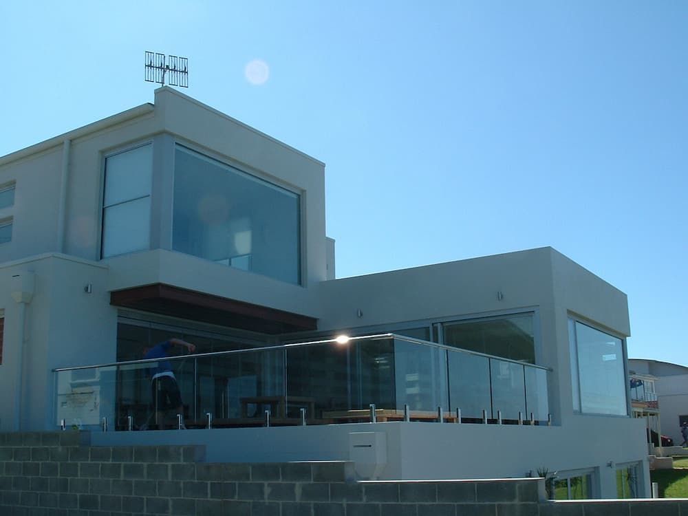A Large White House With Lots Of Windows And A Balcony — South Coast Glass In South Nowra, NSW