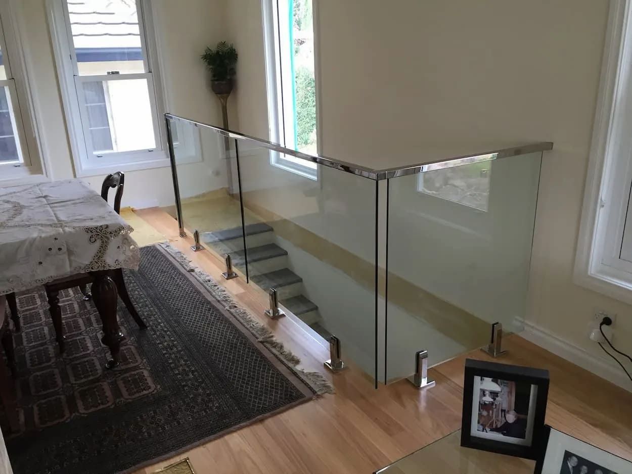 A Living Room With A Glass Railing And Stairs — South Coast Glass In South Nowra, NSW
