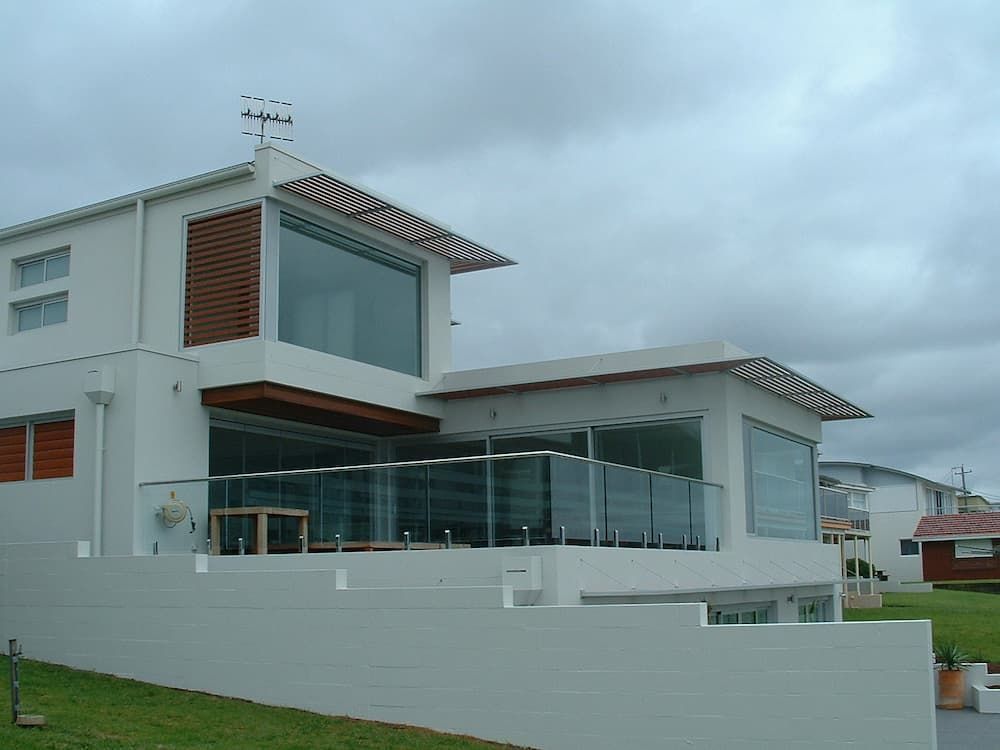 A Large White House With A Lot Of Windows And A Balcony — South Coast Glass In South Nowra, NSW