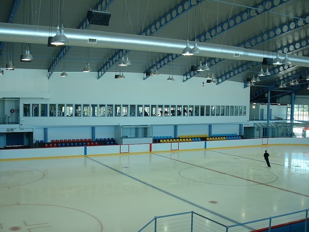 An Empty Ice Rink With A Man Standing In The Middle — South Coast Glass In South Nowra, NSW