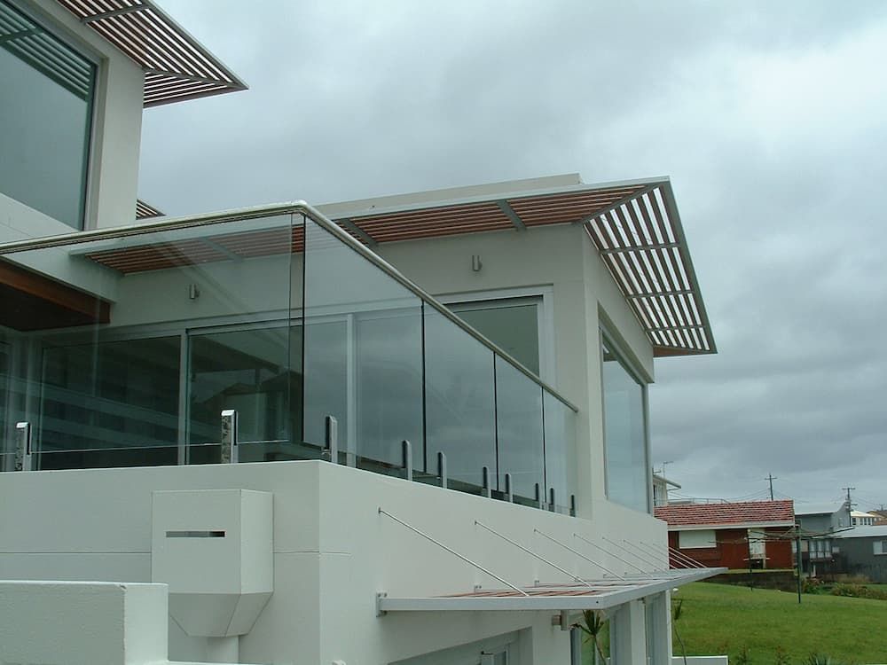 A White House With A Balcony With A Glass Railing — South Coast Glass In South Nowra, NSW