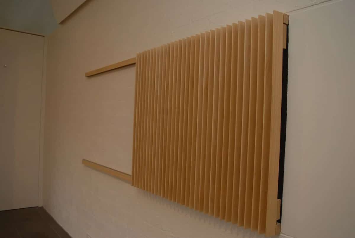 A Wooden Sculpture Is Hanging On A Wall In A Room — South Coast Glass In South Nowra, NSW