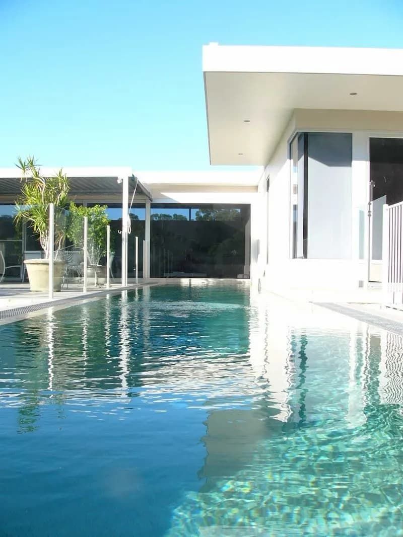 A Large Swimming Pool in Front of A House — South Coast Glass In South Nowra, NSW