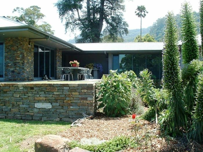 A House With A Stone Wall In Front Of It — South Coast Glass In South Nowra, NSW
