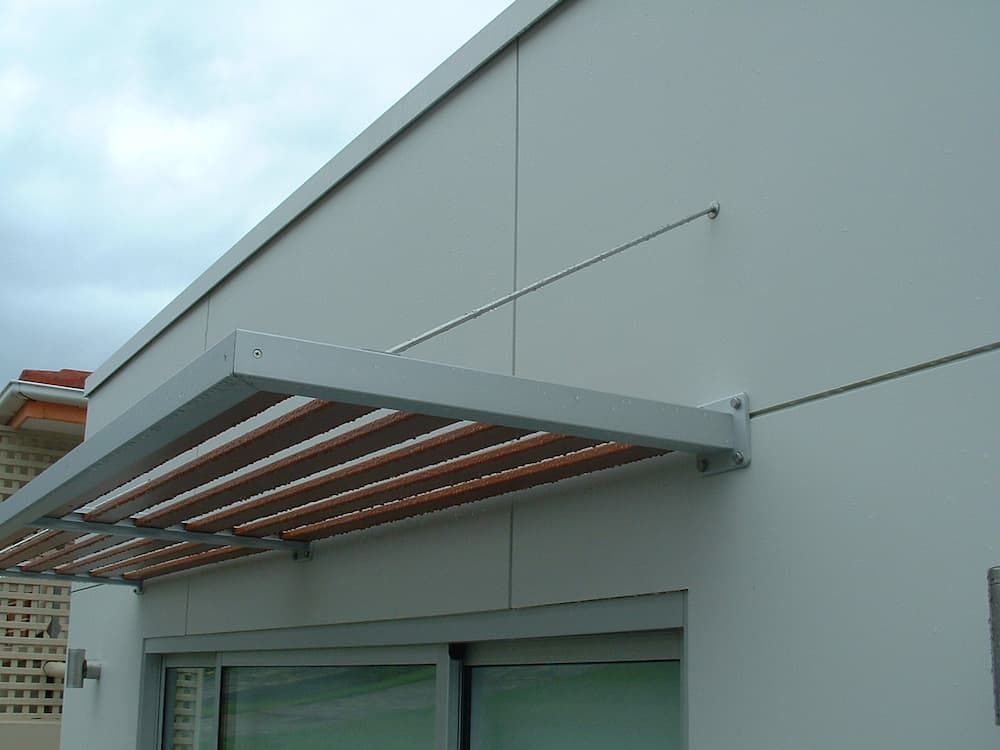 A White Building With A Canopy Over A Window — South Coast Glass In South Nowra, NSW