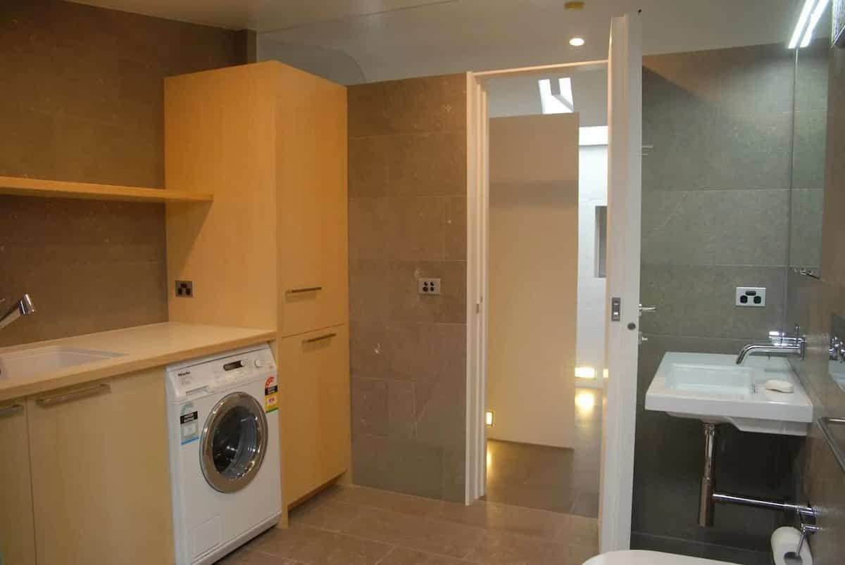 A Bathroom With A Washer And Dryer And A Sink — South Coast Glass In South Nowra, NSW