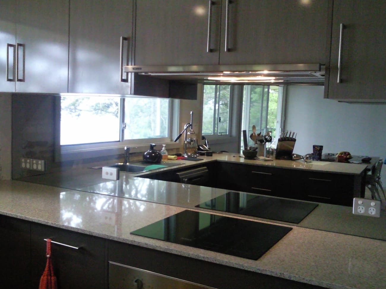 A Kitchen With A Stove Top Oven And A Large Mirror — South Coast Glass In South Nowra, NSW