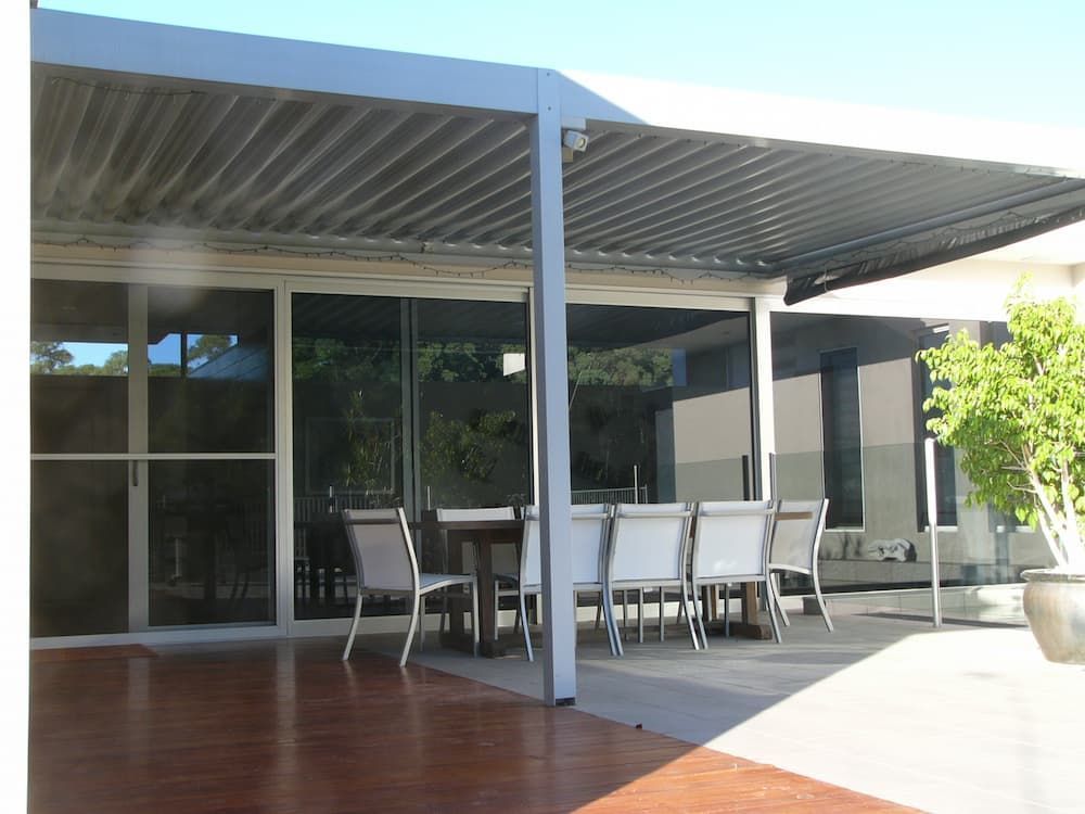 A Patio With A Table And Chairs Under A Canopy — South Coast Glass In South Nowra, NSW