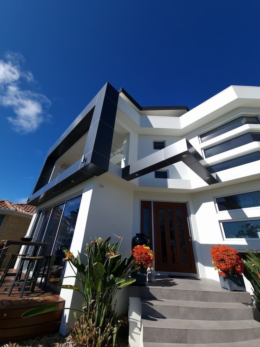 A Large White House With A Blue Sky In The Background — South Coast Glass In South Nowra, NSW