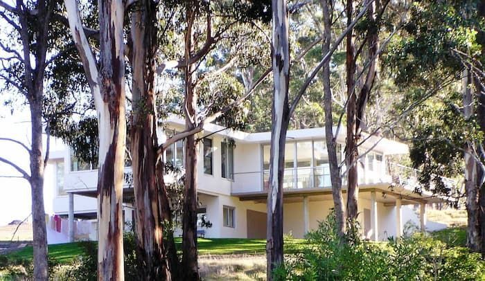 A White House Is Surrounded By Trees And Bushes — South Coast Glass In South Nowra, NSW