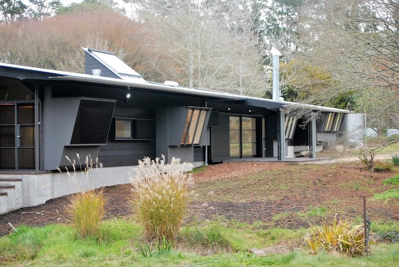 A Large House Is Sitting In The Middle Of A Grassy Field — South Coast Glass In South Nowra, NSW